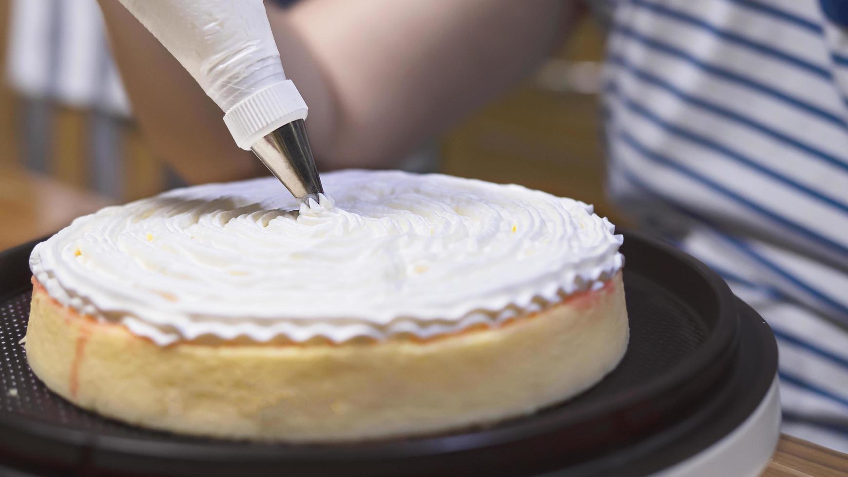 Lady making cream cake - people with homemade bakery concept photo