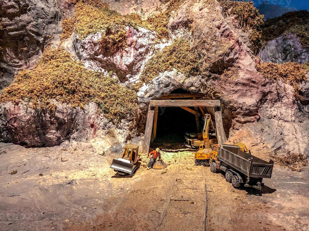 mini models miner front of the cave for mining. photo