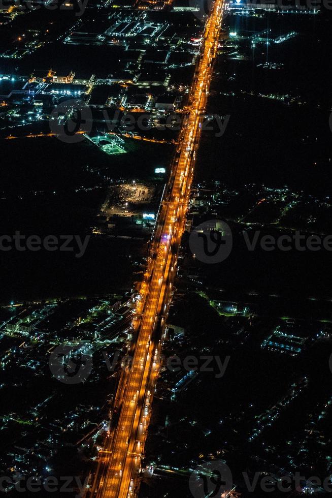 Night view from the jetplane in twilight time with the red sky and light of the city. photo