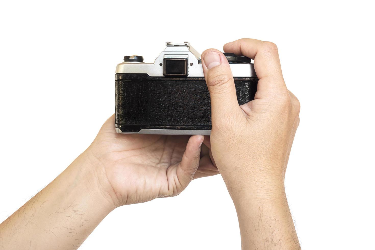 Man holding film camera ready to take photo over white background