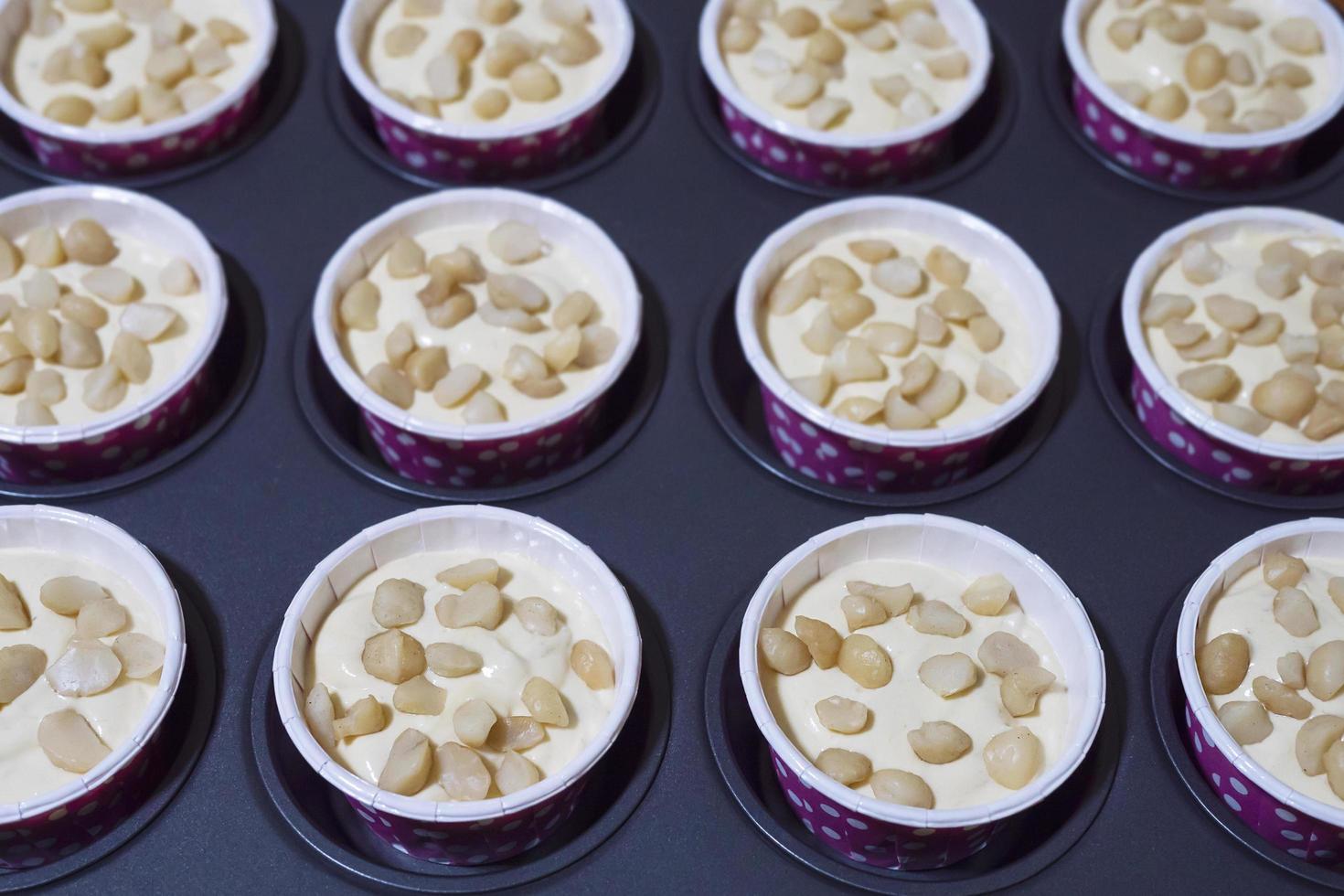 Homemade banana muffins cake with macadamia nut tray - home bakery concept photo