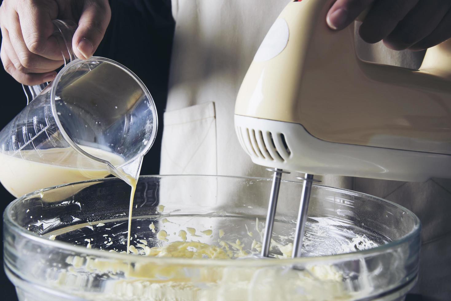 Lady making cake putting cream using spatula - homemade bakery cooking concept photo