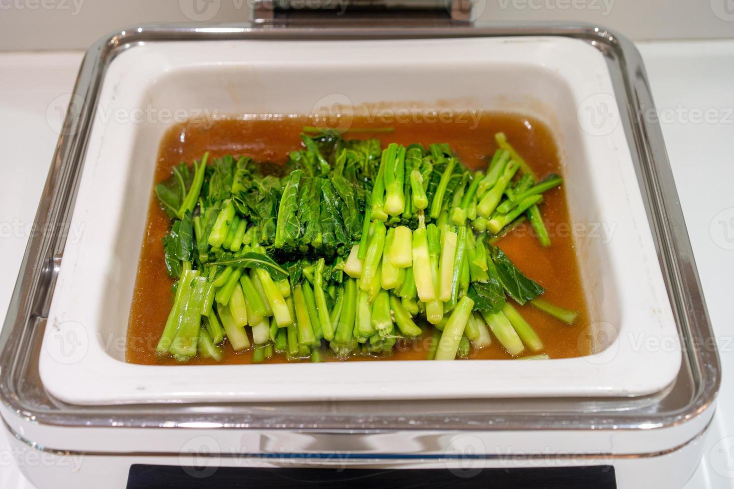 Stir Kale in large white square bowl at Thailand resort. photo
