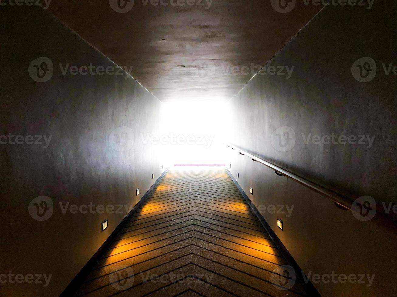 walk way and hand holder beside forward to the light exit or light of hope. photo