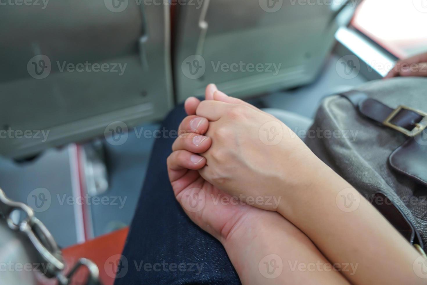 first time couple lovers hand holding together on the bus. photo