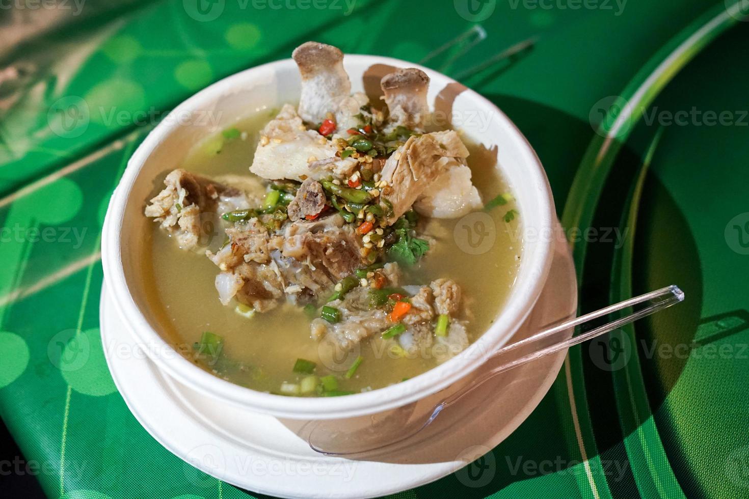 Sour spicy pork spare rib soup, Thai soup style from foodtruck shop at foodstreet, Bangkok, Thailand. photo