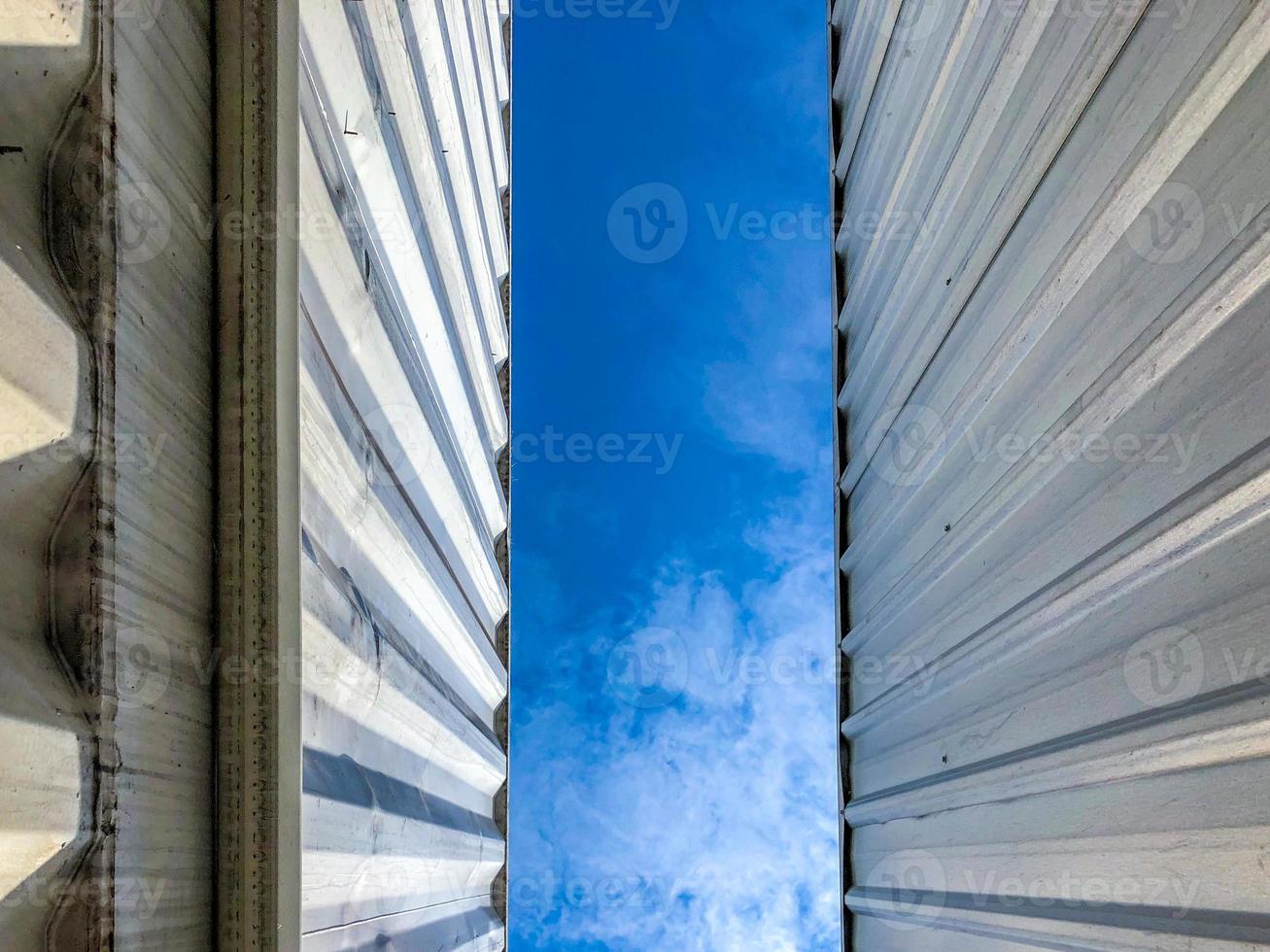 Metal sheet pattern with the blue sky in the middle. photo