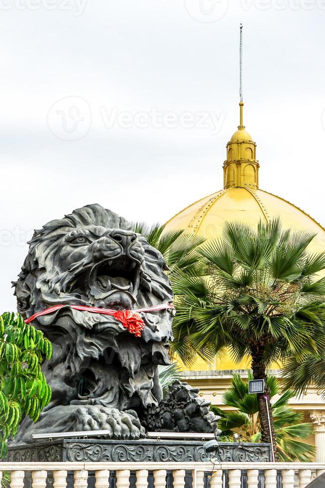 big black lion statue front of building. photo
