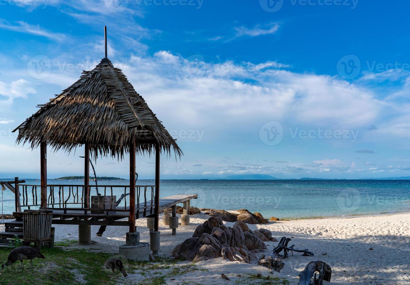 Pavilion made form leaf in vintage and island style settle on the beach with the sea, open sky background, Munnok Island, Thailand. photo