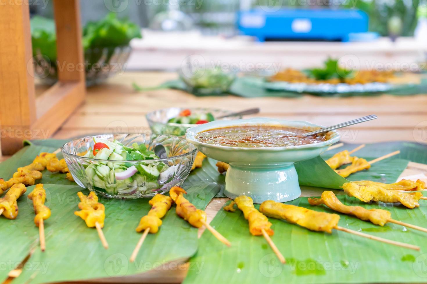 grilled Satay pork, Thailand traditional popular food stick with wood strick, cooked ready to eat with specific sauce beside. photo