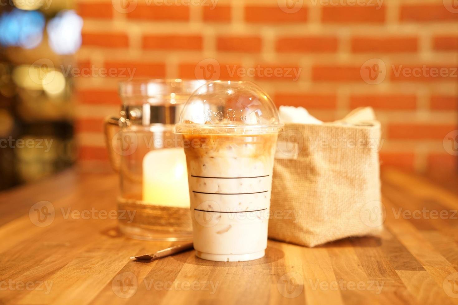 Take away Latte with Brick background on the wood table photo