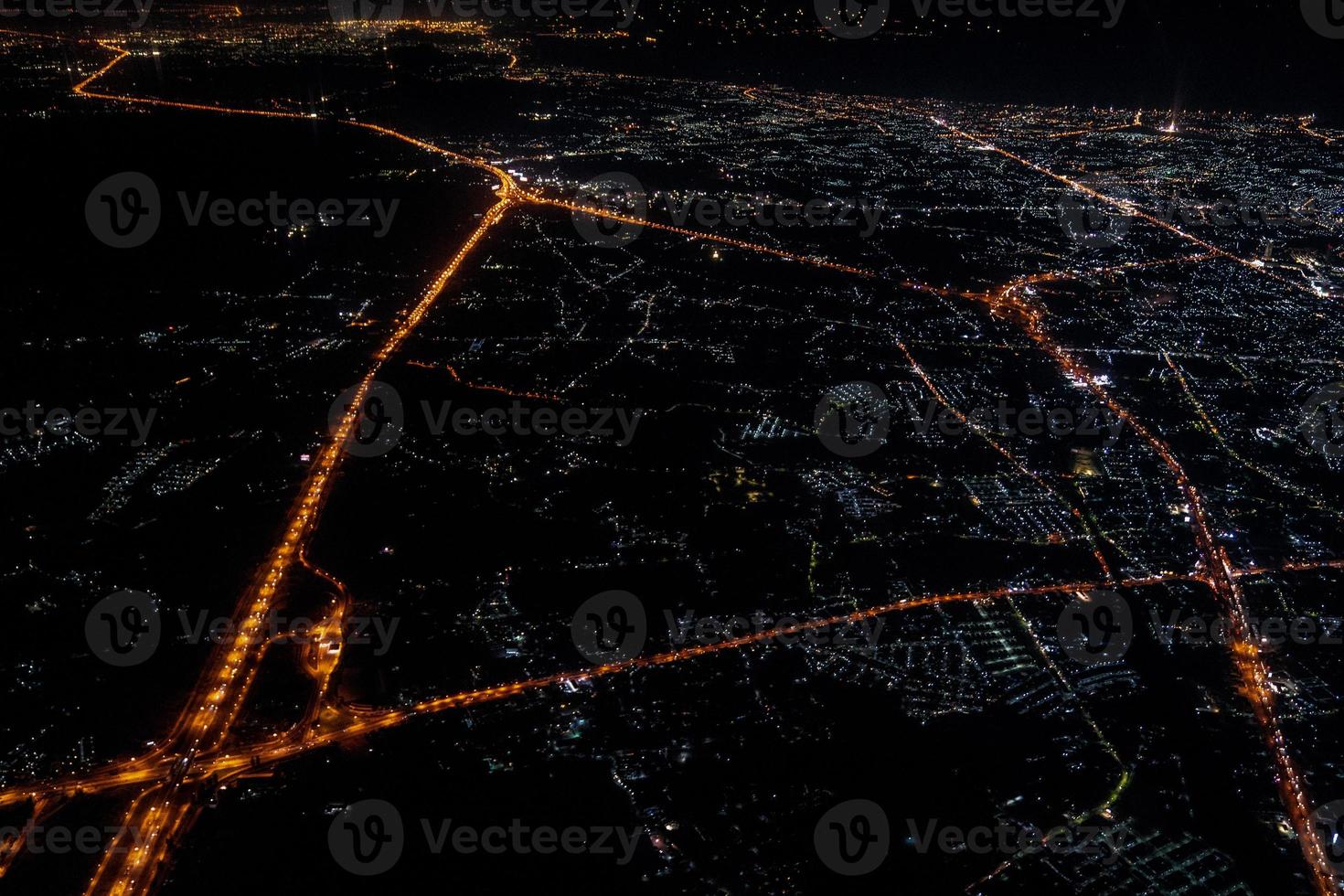 Night view from the jetplane in twilight time with the red sky and light of the city. photo