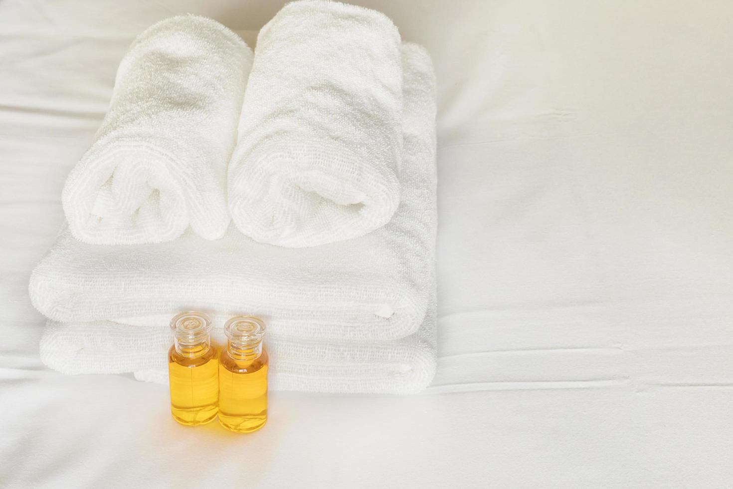 Hotel towel with shampoo and soap bottle set on white bed 9297367 Stock Photo at Vecteezy
