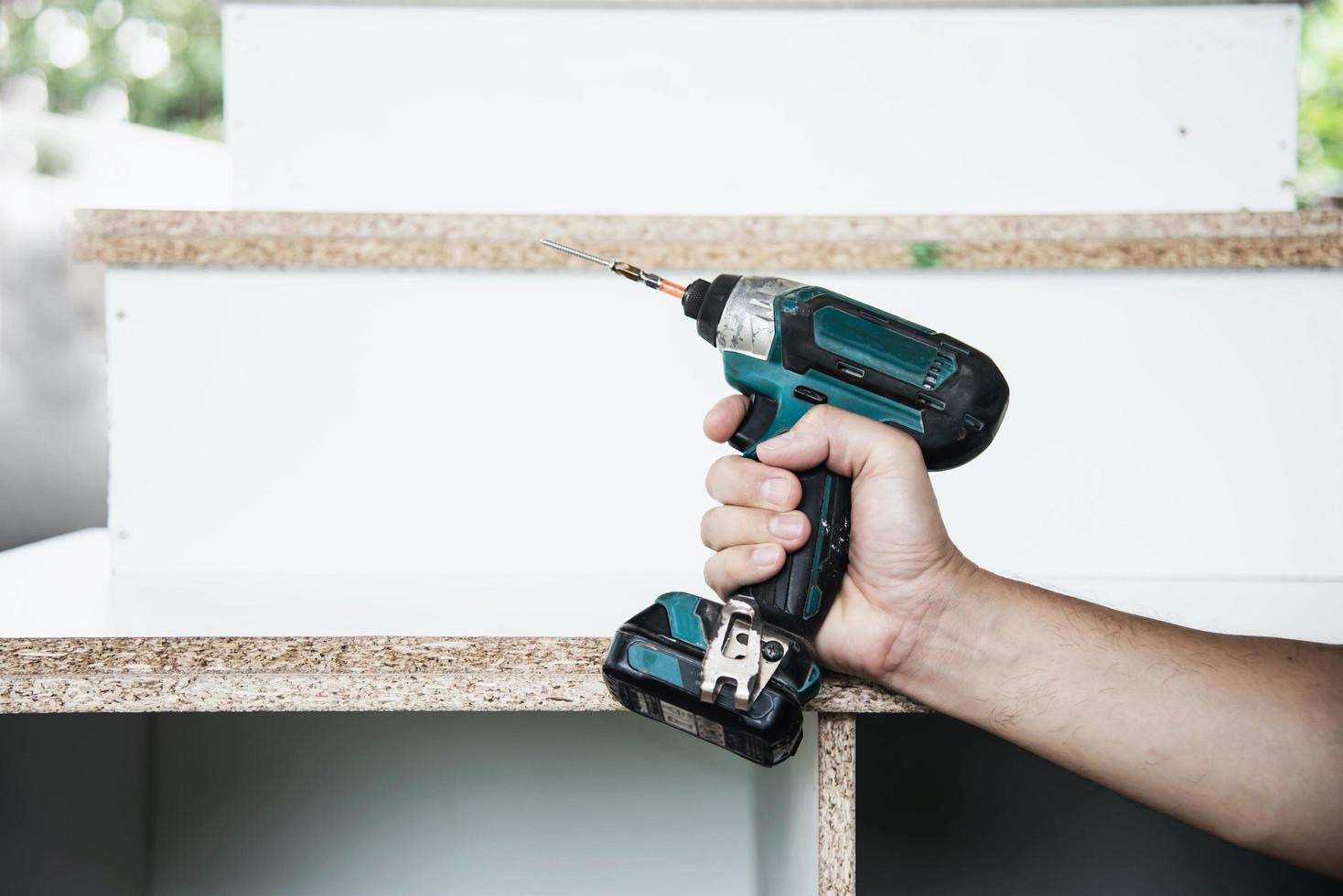 Man preparing electric router laminate trimmer machine tool - carpenter workshop concept photo