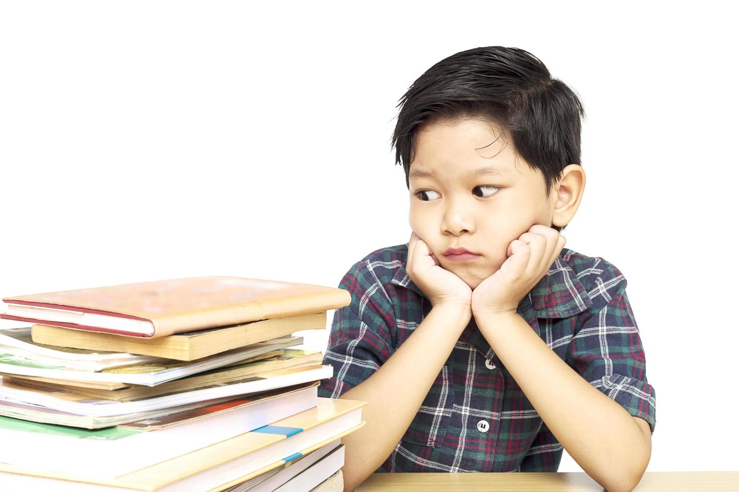A boy is unhappy doing homework photo