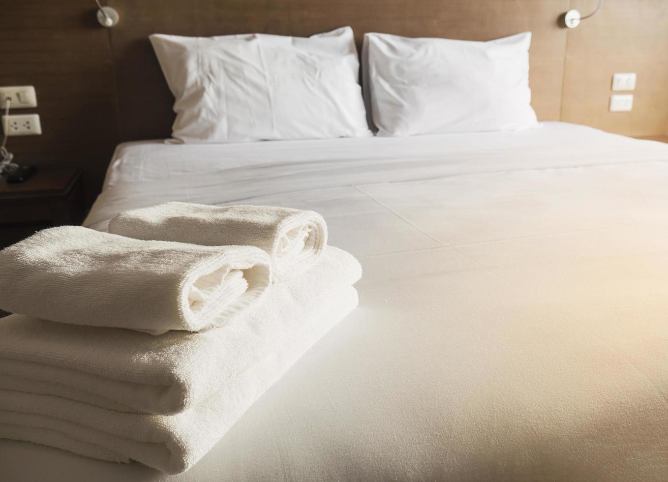 White bedding and towel set in modern hotel photo