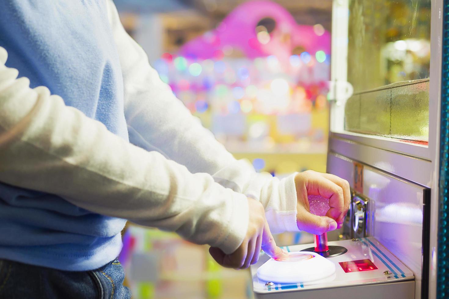 Soft focus photo of kid playing coin game in toy land