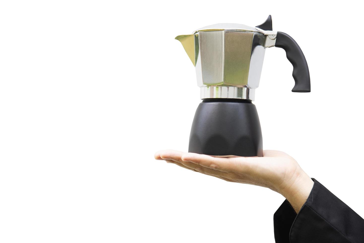 Barista's hand holding moka pot over white background photo