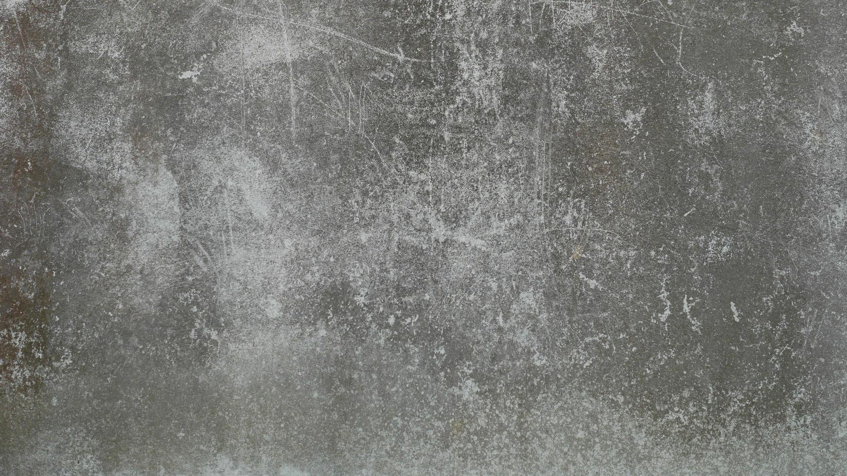 The old cement wall was weathered, the surface was scratched, the surface was scratched and damaged. For a mysterious retro-conservative background. photo