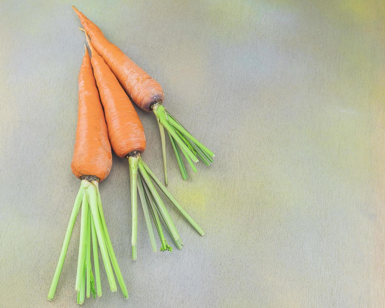 Fresh carrot on a wooden table photo