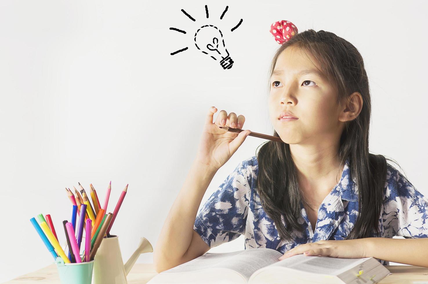 A girl is happily reading a book photo