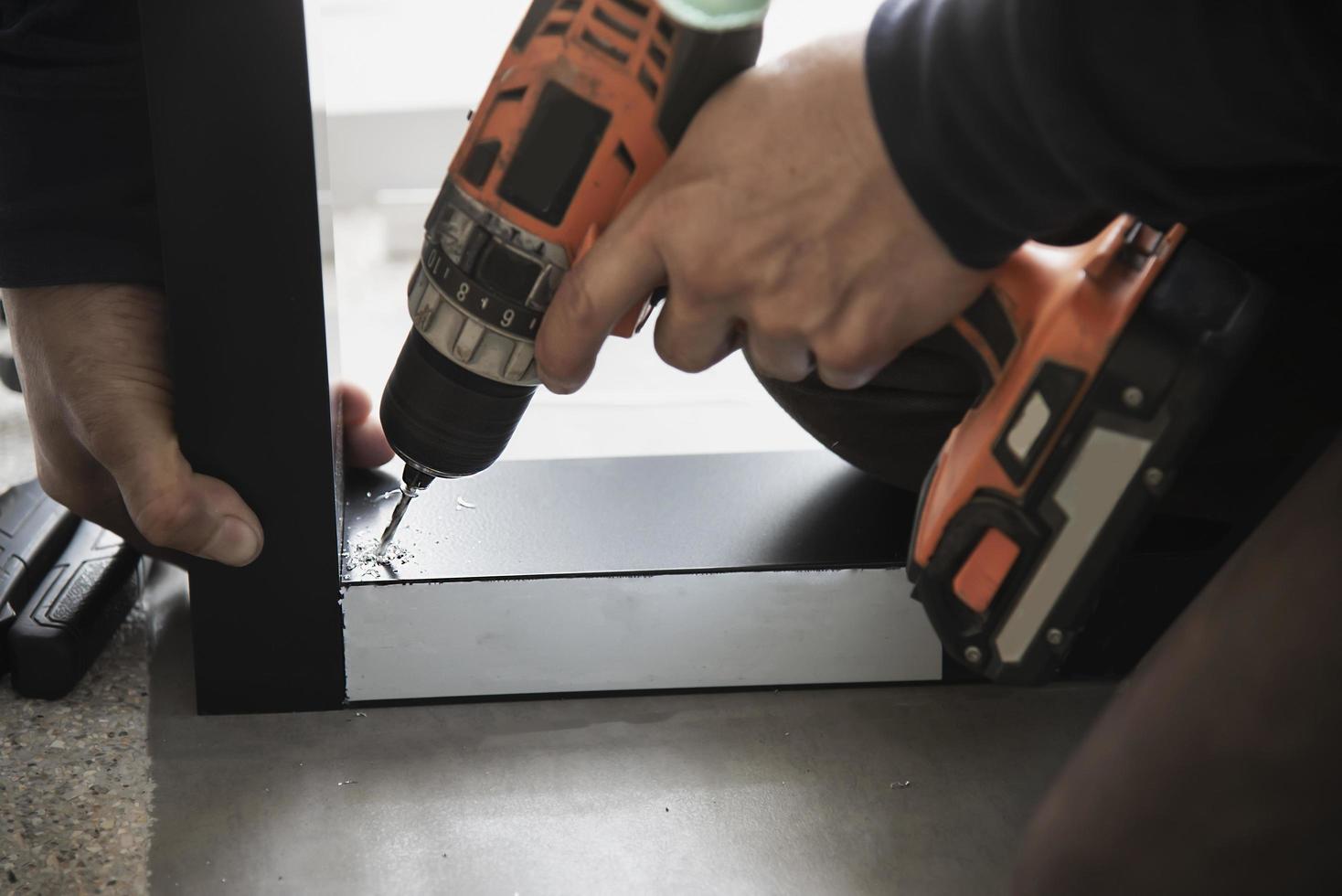 Man doing aluminum frame with glasses and wire screen door and window installation work in construction site photo