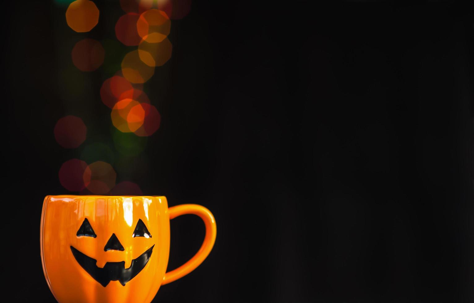 Halloween pumpkin face buckets with colorful candy photo