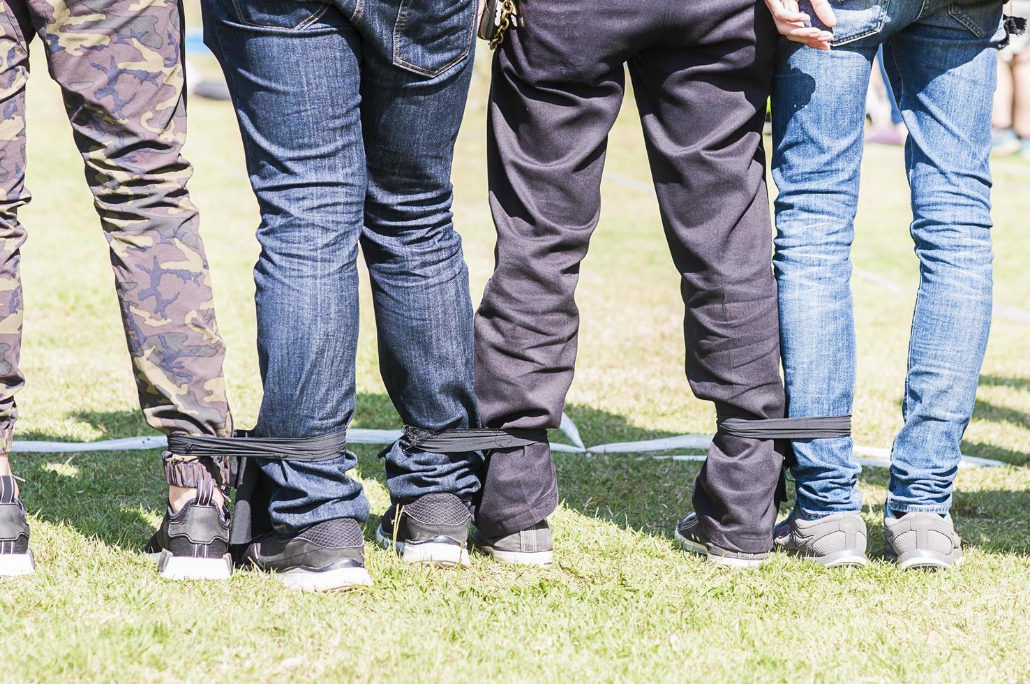 Five legged race outdoor party game, harmonious unity concept photo