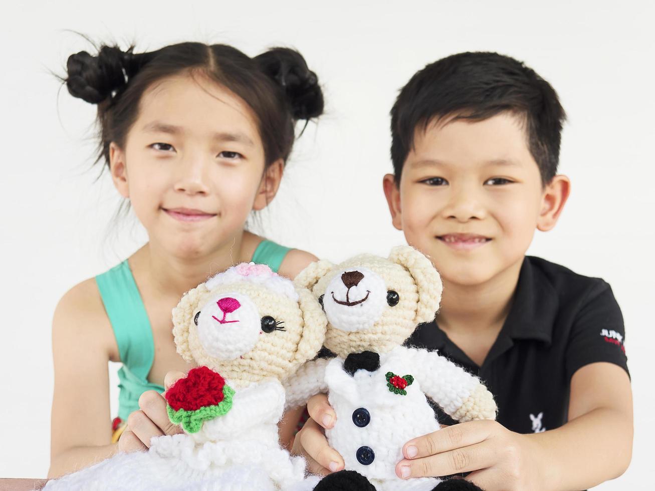 Asian kids are playing wedding bear dolls photo