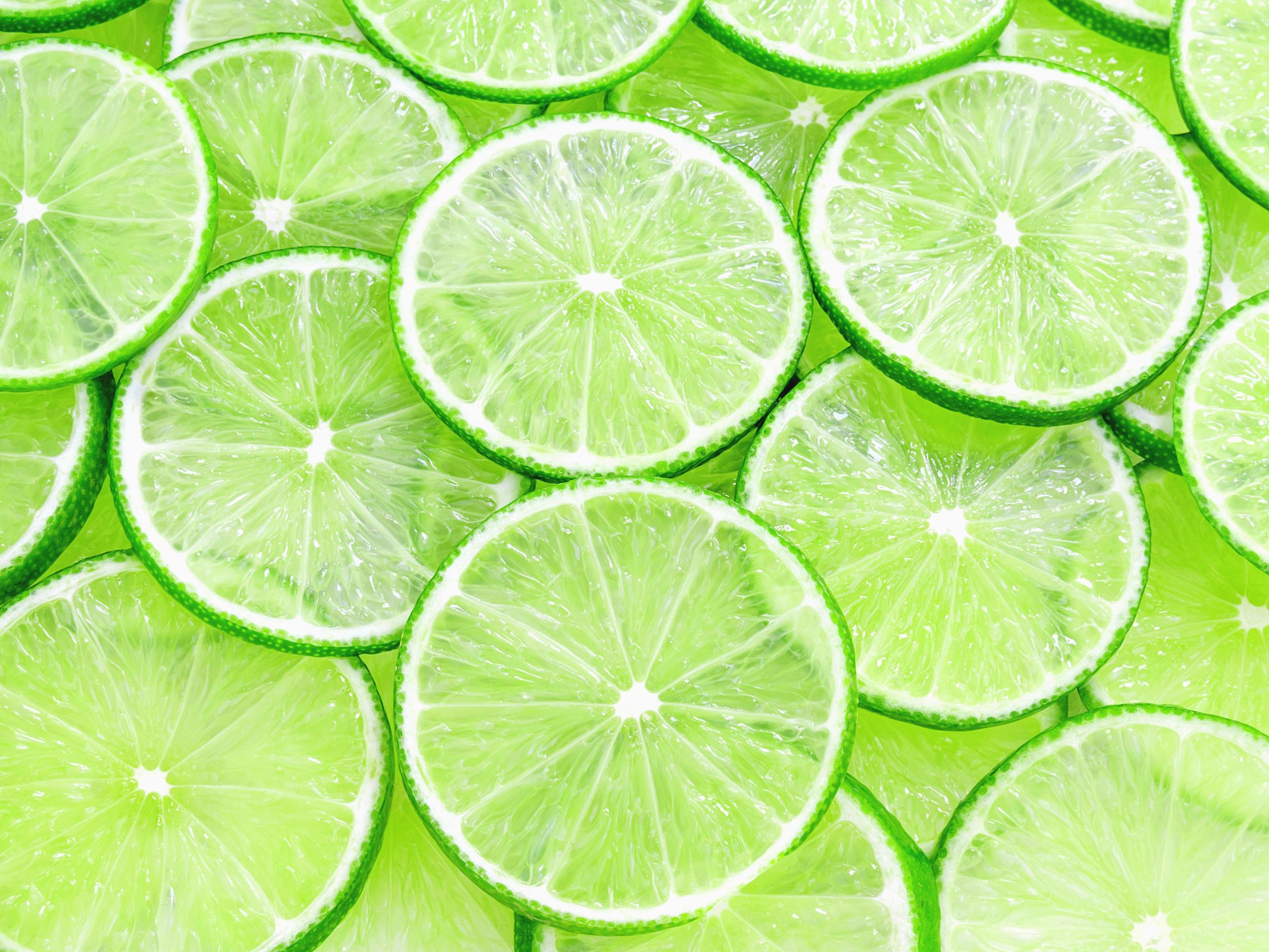 Lime slices background 9298894 Stock Photo at Vecteezy
