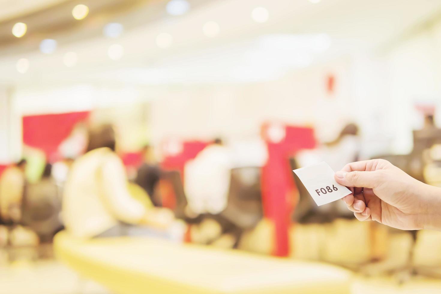 Man is holding queue card while waiting in the modern reception area photo