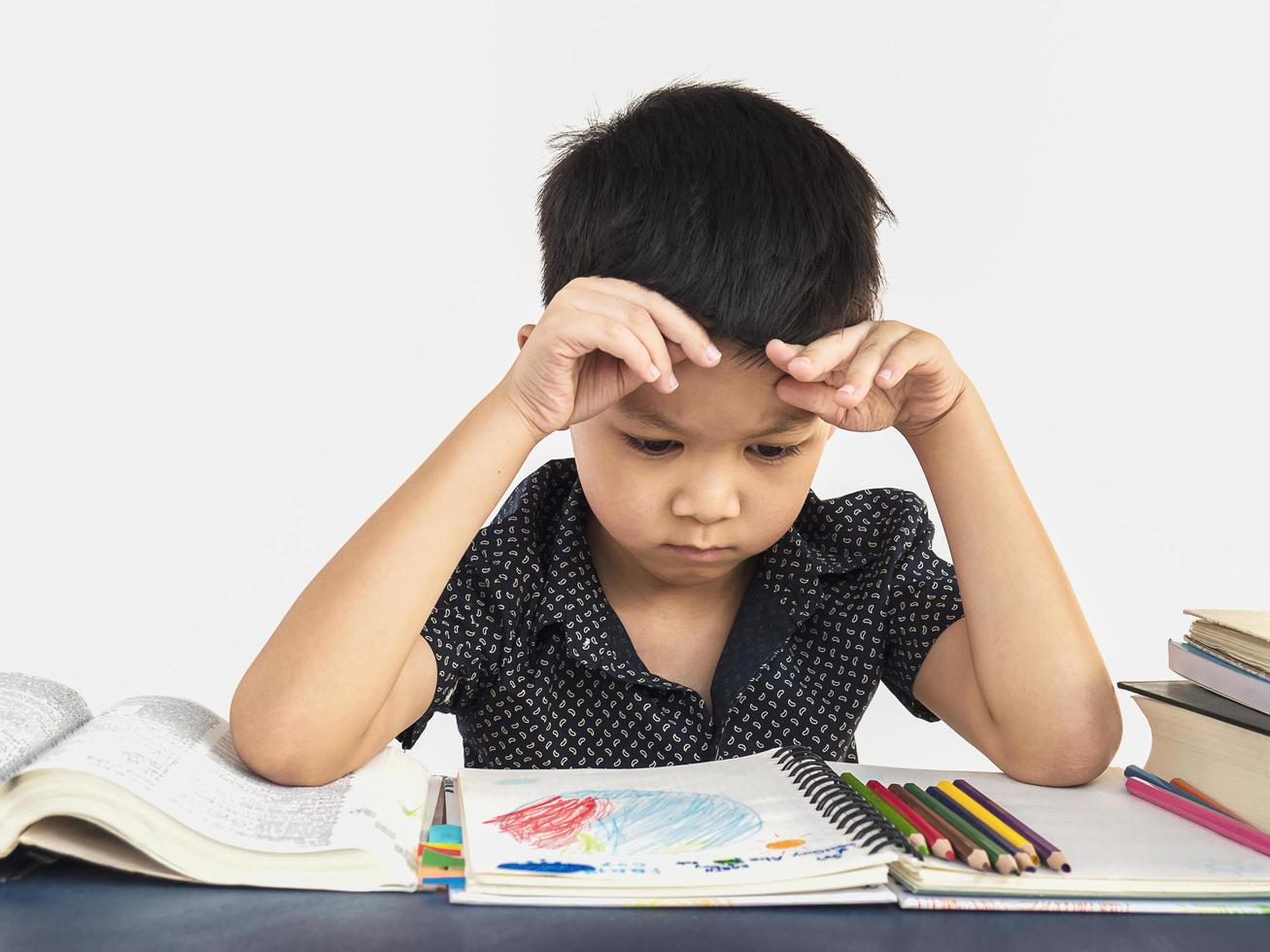 A boy is unhappy doing homework photo