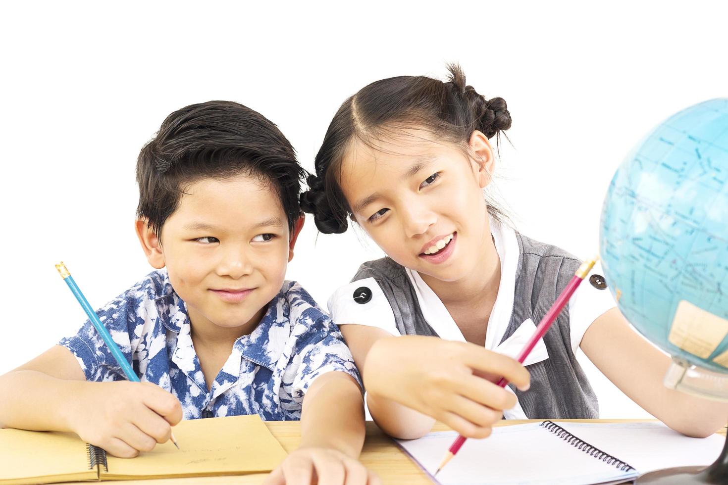 Asian kids are studying the globe over white background photo