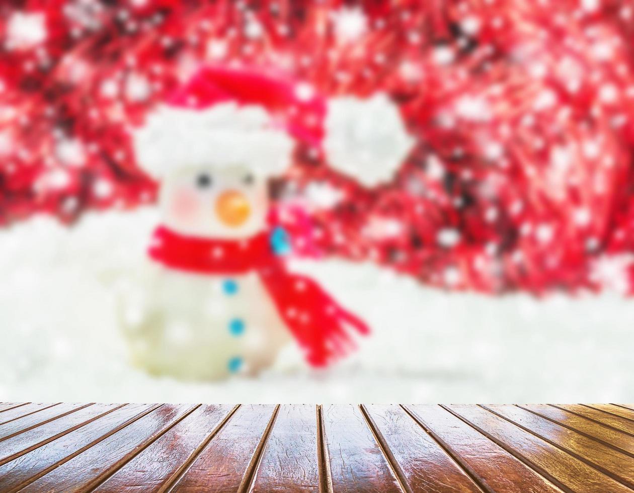 Brown wooden planks blurred snow man on a white background and red decorated Christmas and New Year. photo