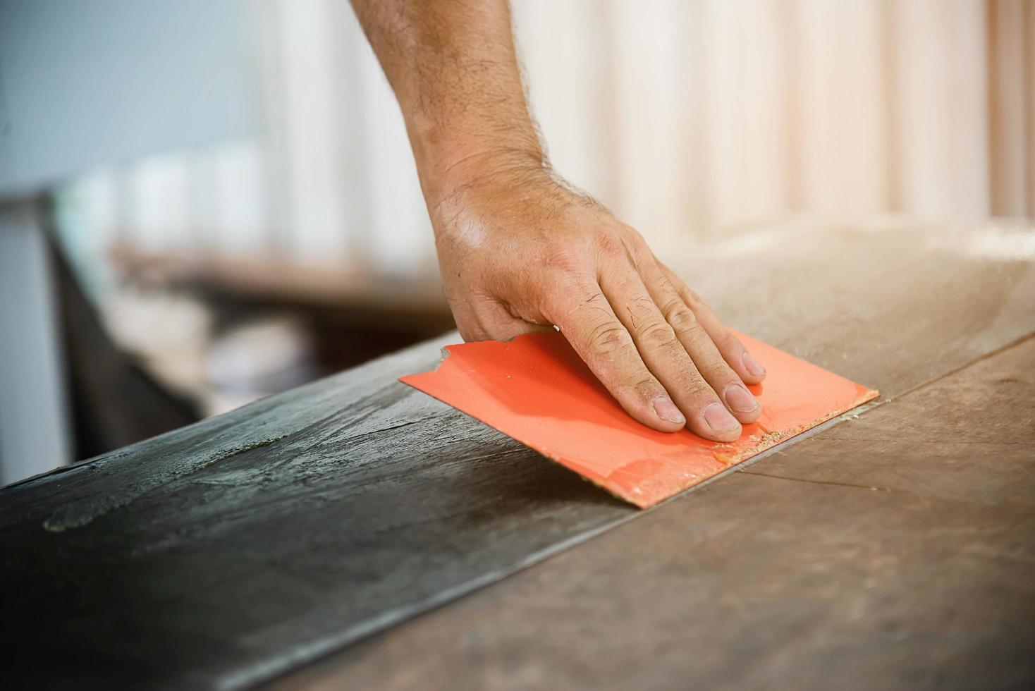 Man preparing electric router laminate trimmer machine tool - carpenter workshop concept photo