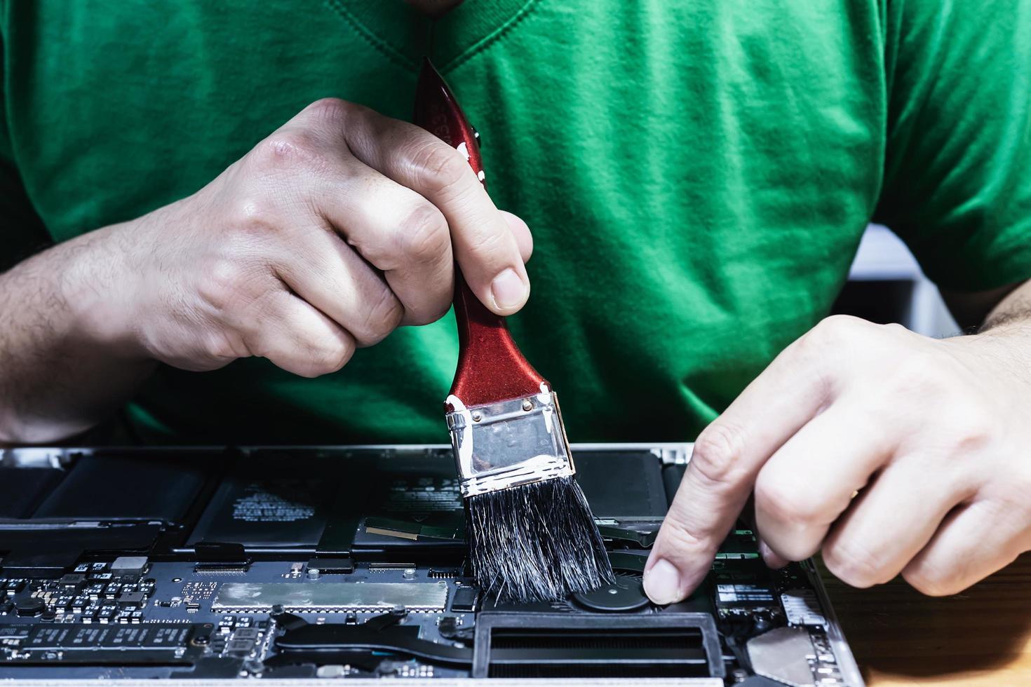 Man fixing laptop computer - technology computer reparing concept photo