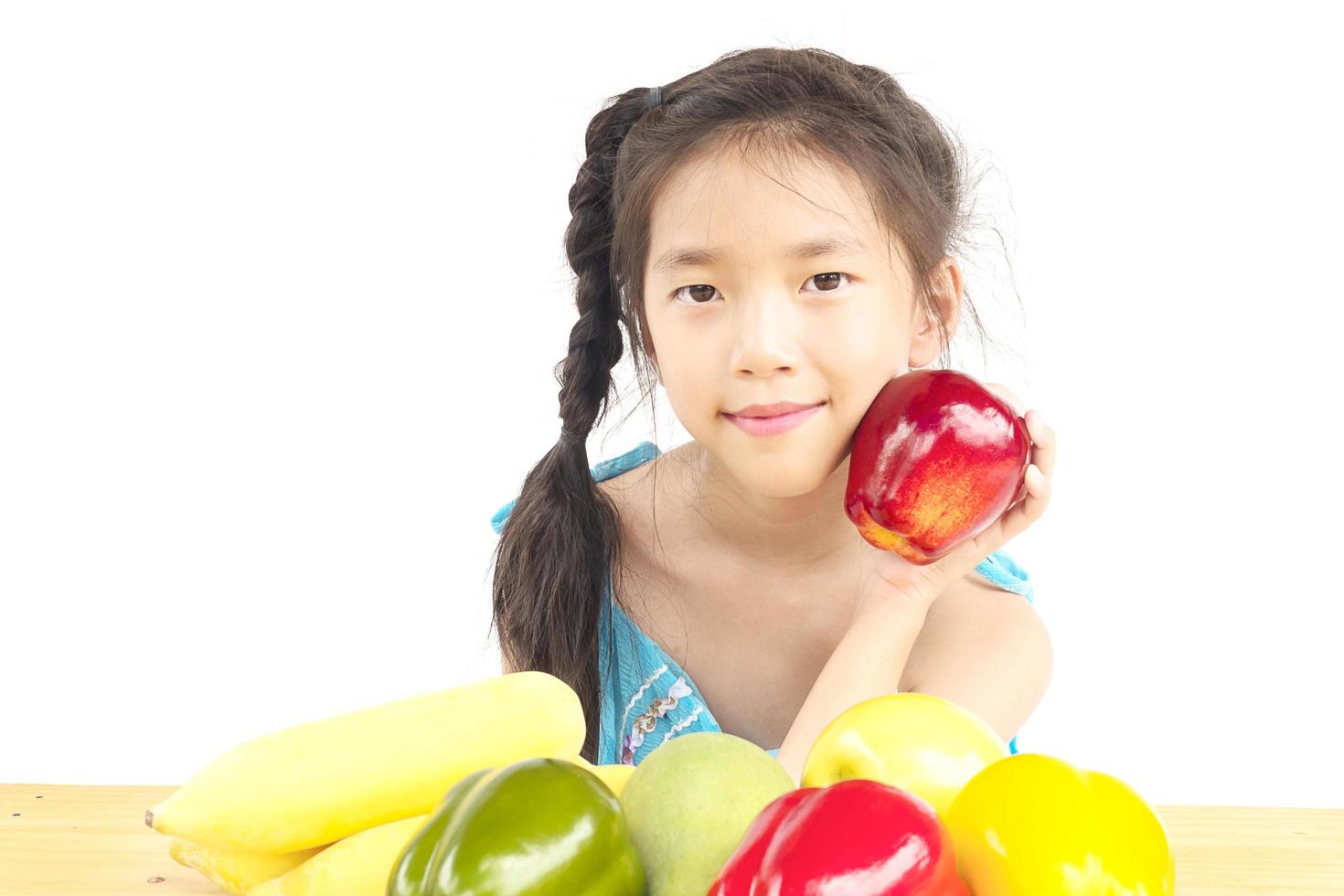 Asian healthy gril showing happy expression with variety colorful fruit and vegetable over white background photo