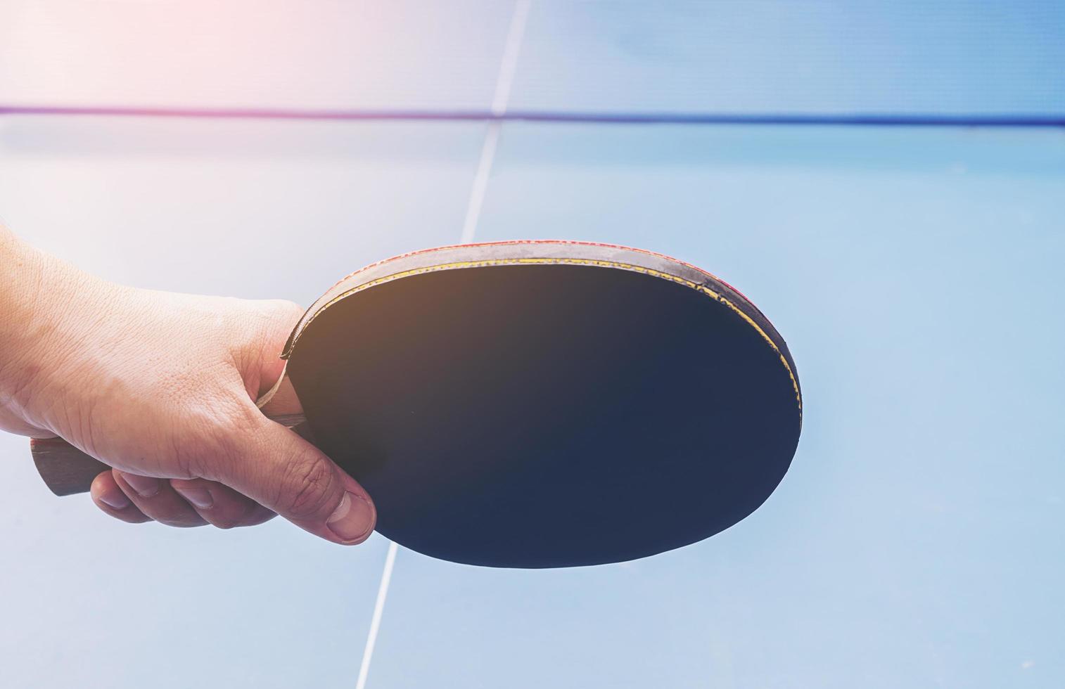 Table tennis equipment on blue table photo