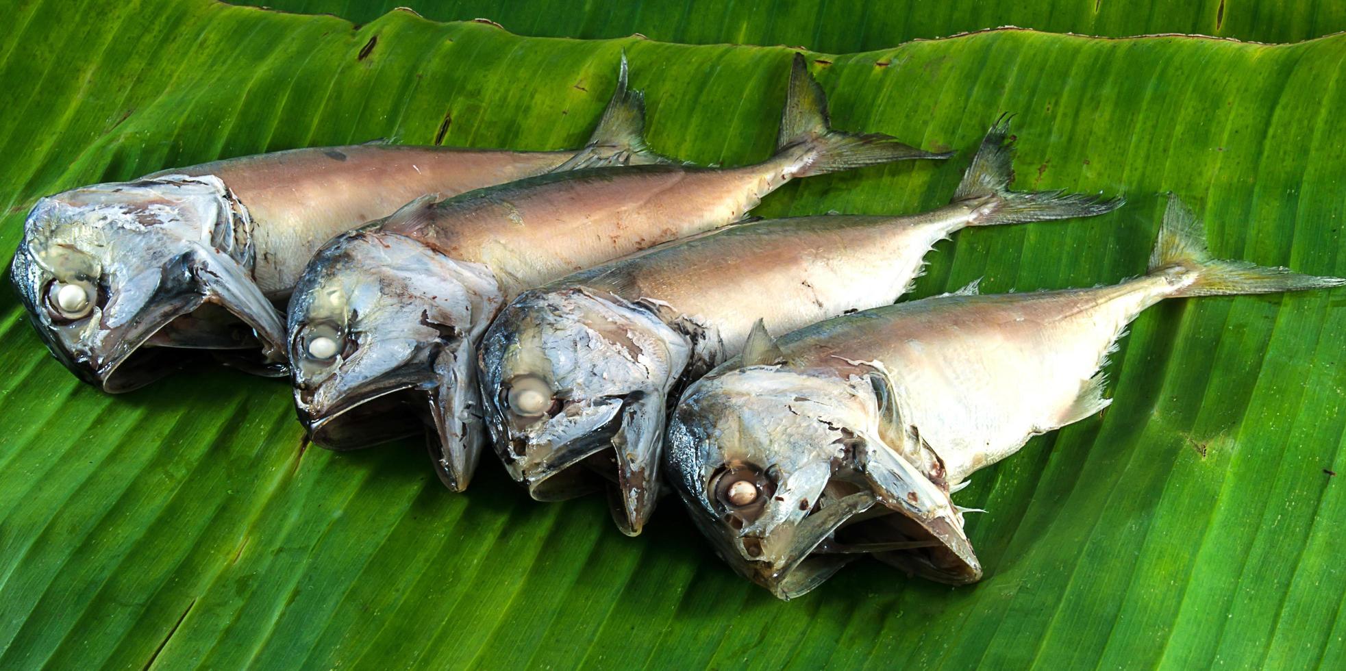 Steamed mackerel on banana leaves ready to be cooked photo