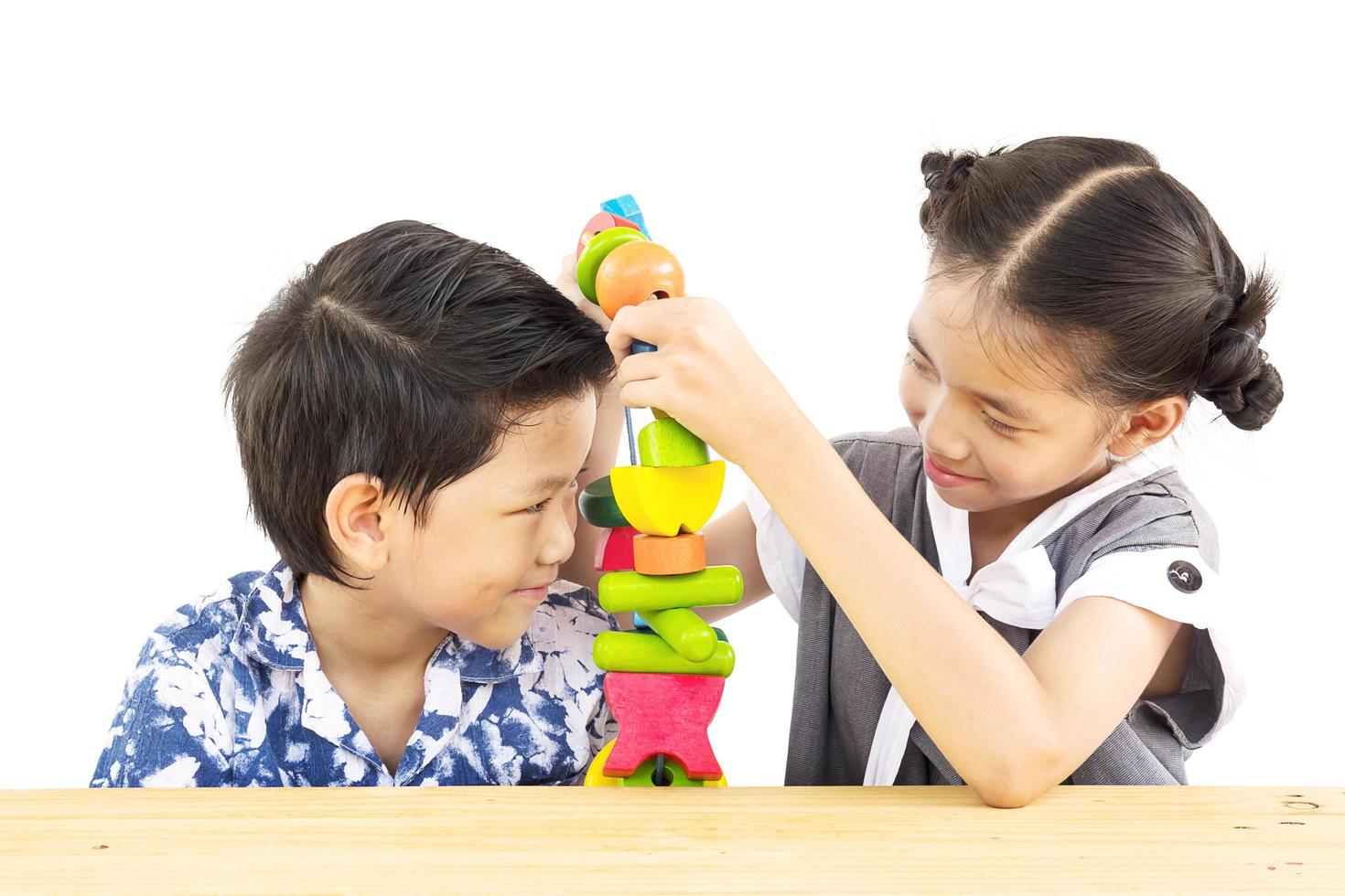 Asian boy and girl are happily playing colorful wood block toy photo