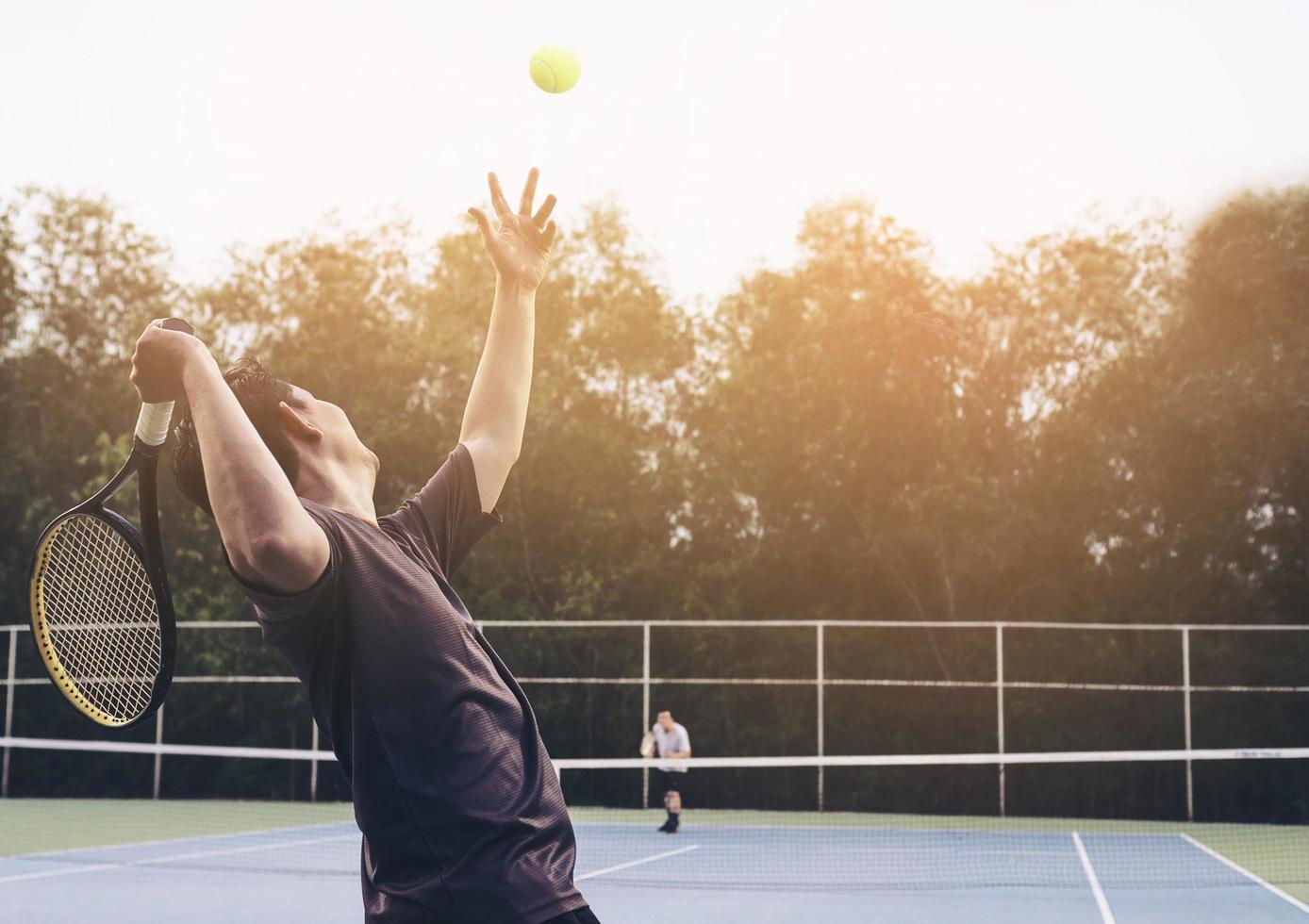 Tennis match which a serving player photo