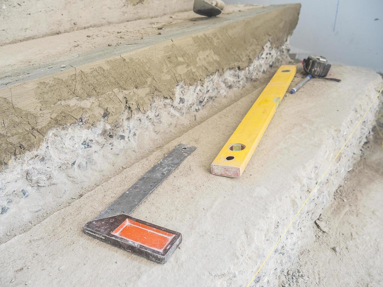 Construction hand tools putting on reinforce concrete stair during constructing photo