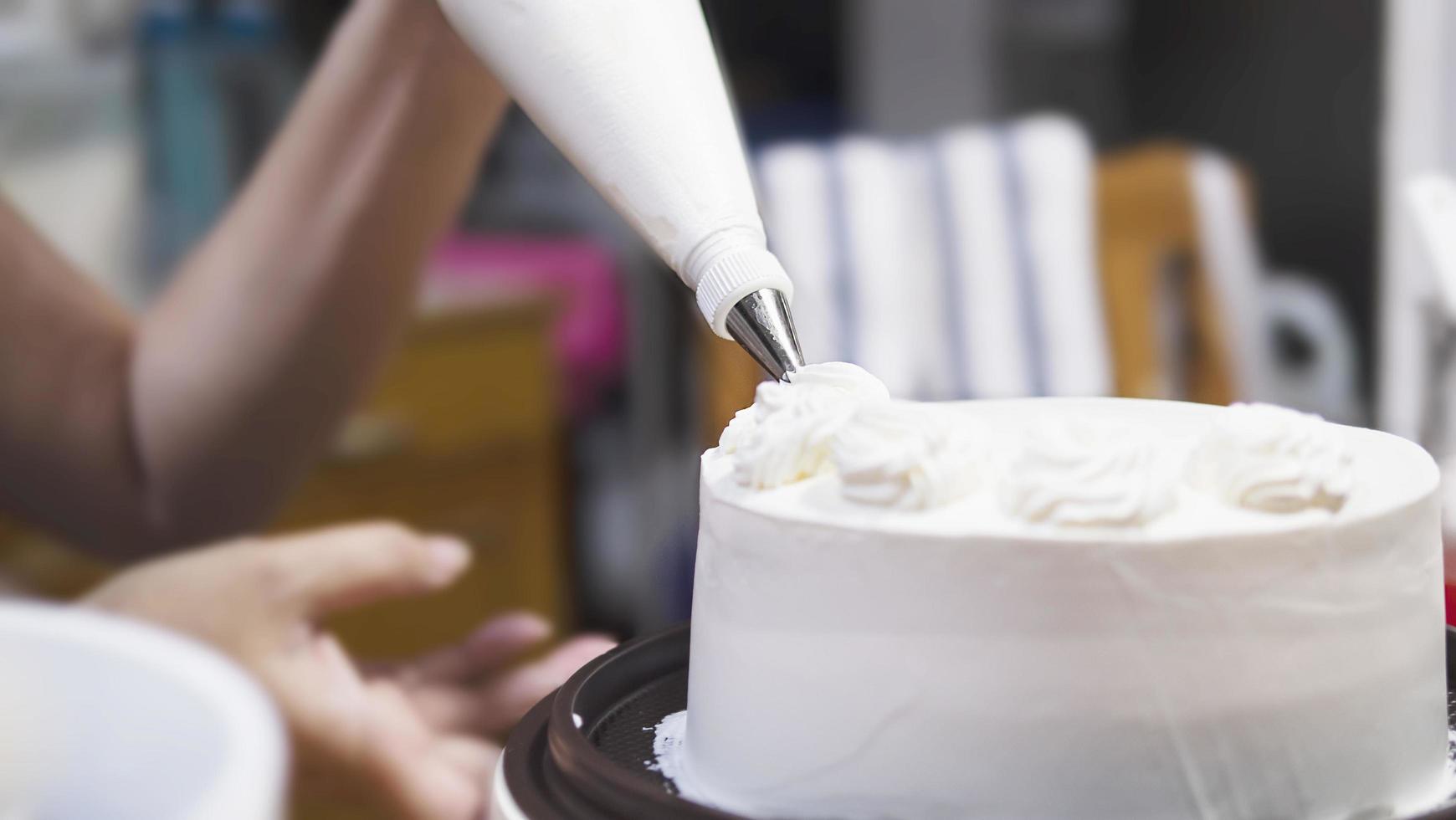 Lady making cream cake - people with homemade bakery concept photo