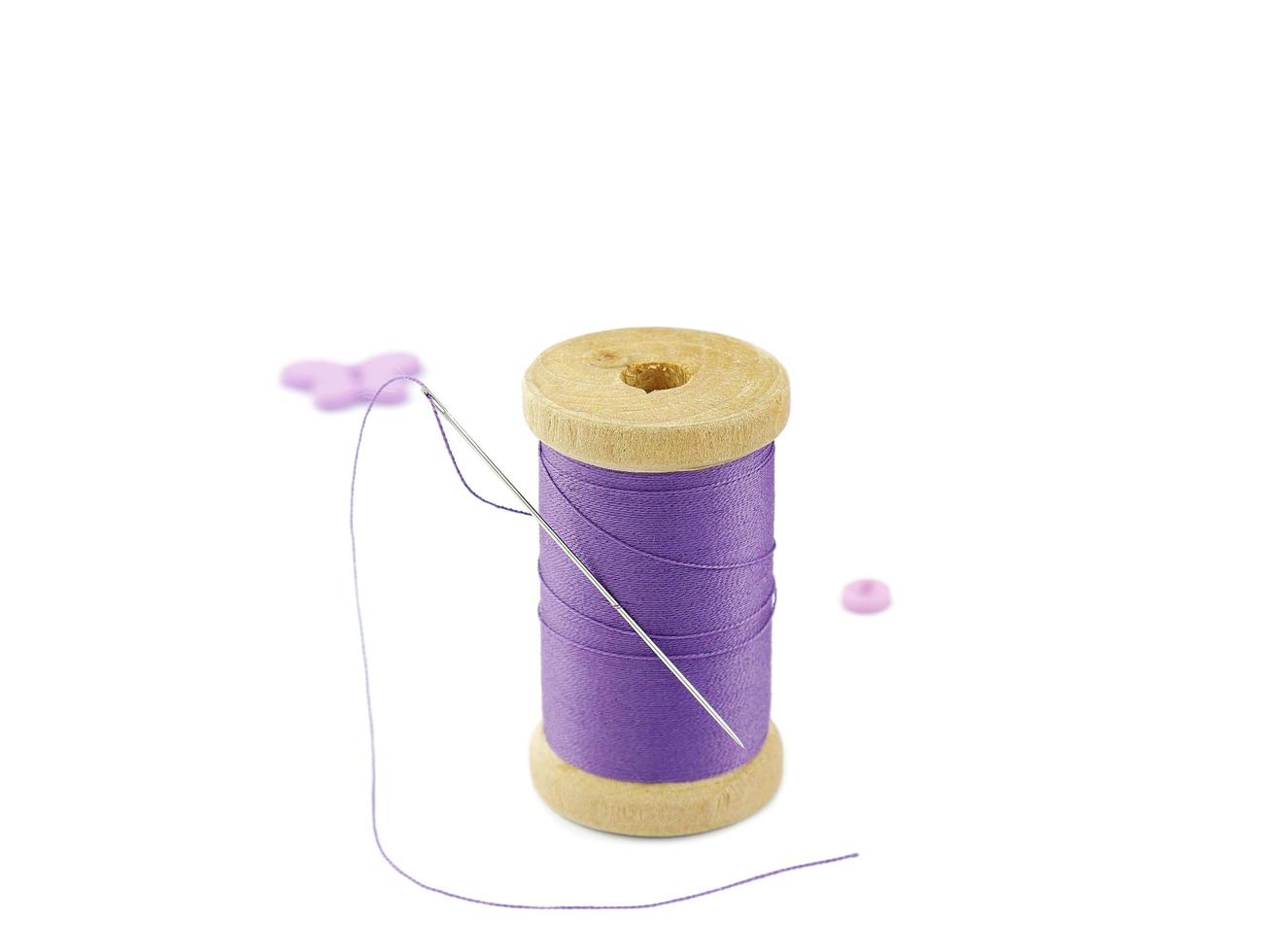 Isolated wooden spool of thread embroidery work object over white background photo