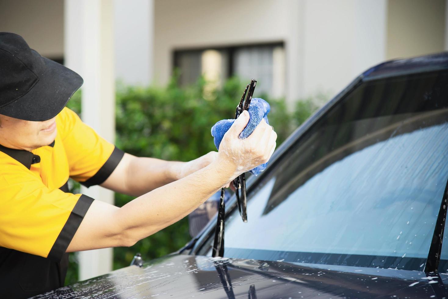 Man wash car using shampoo - every day life car care concept photo