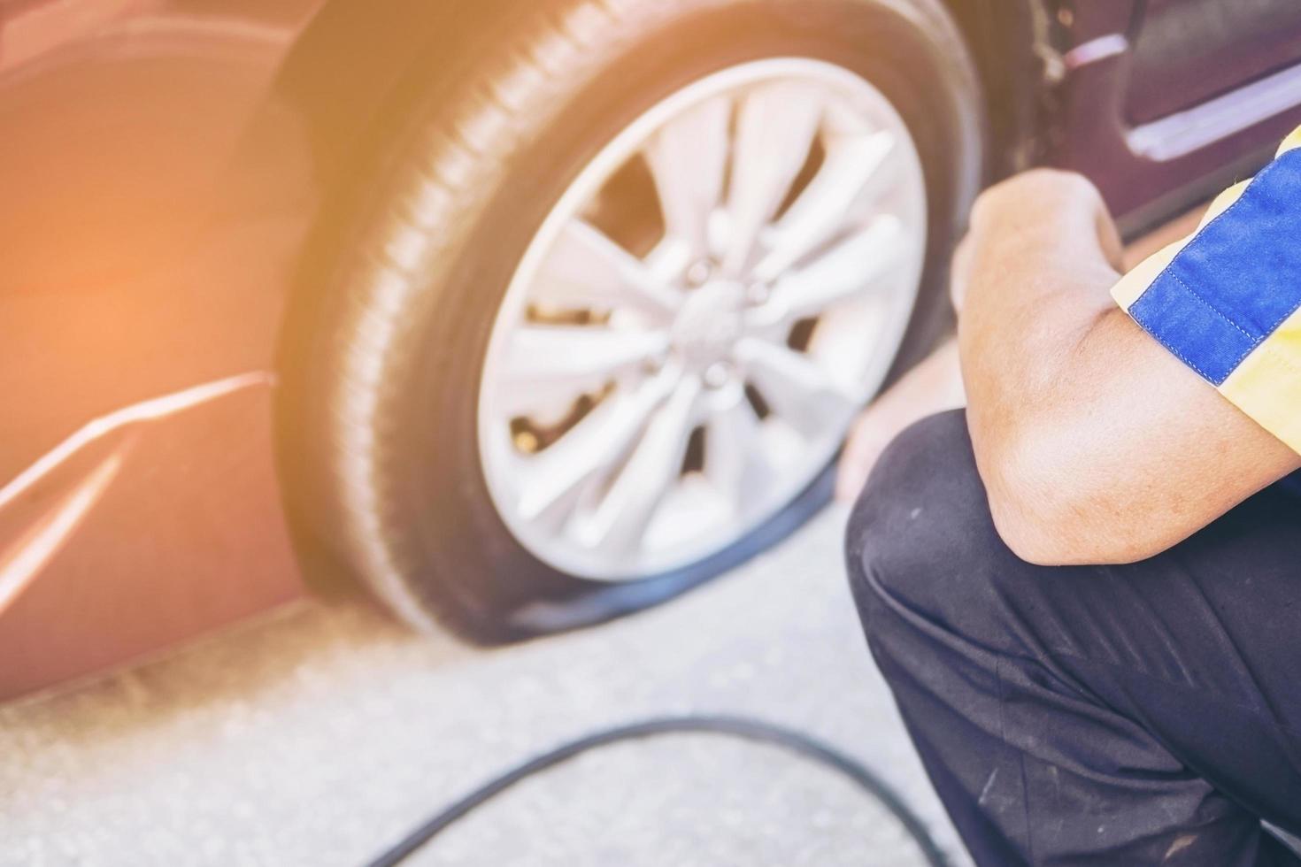 Technician is repairing car flat tire photo