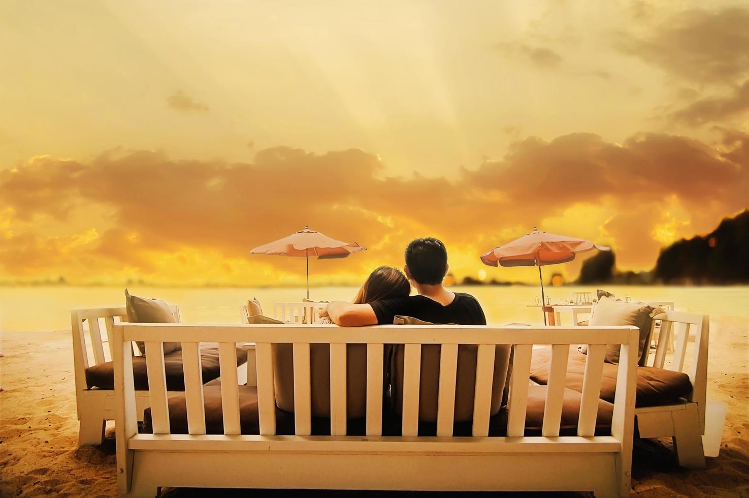 Warm tone photo of Asian Thai couple on the Pataya beach, Thailand, during twilight time