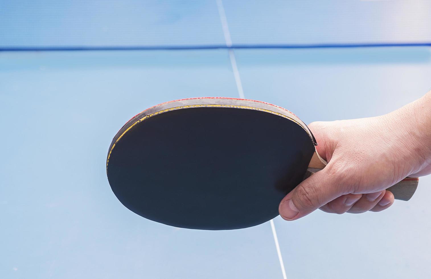 Table tennis equipment on blue table photo