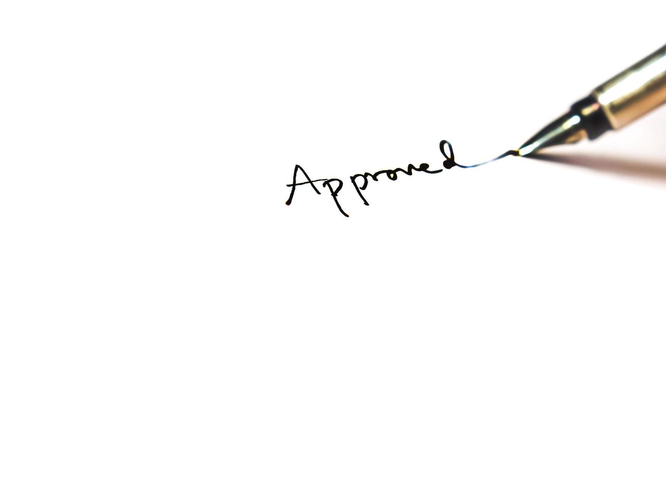 Hand signing approval word one white paper photo