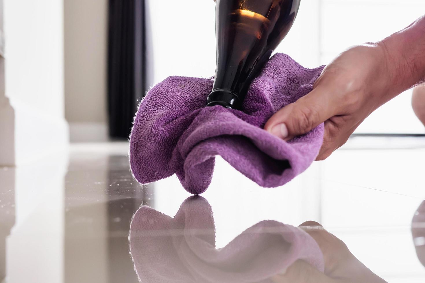 Construction man cleaning tile floor finishing using thinner photo